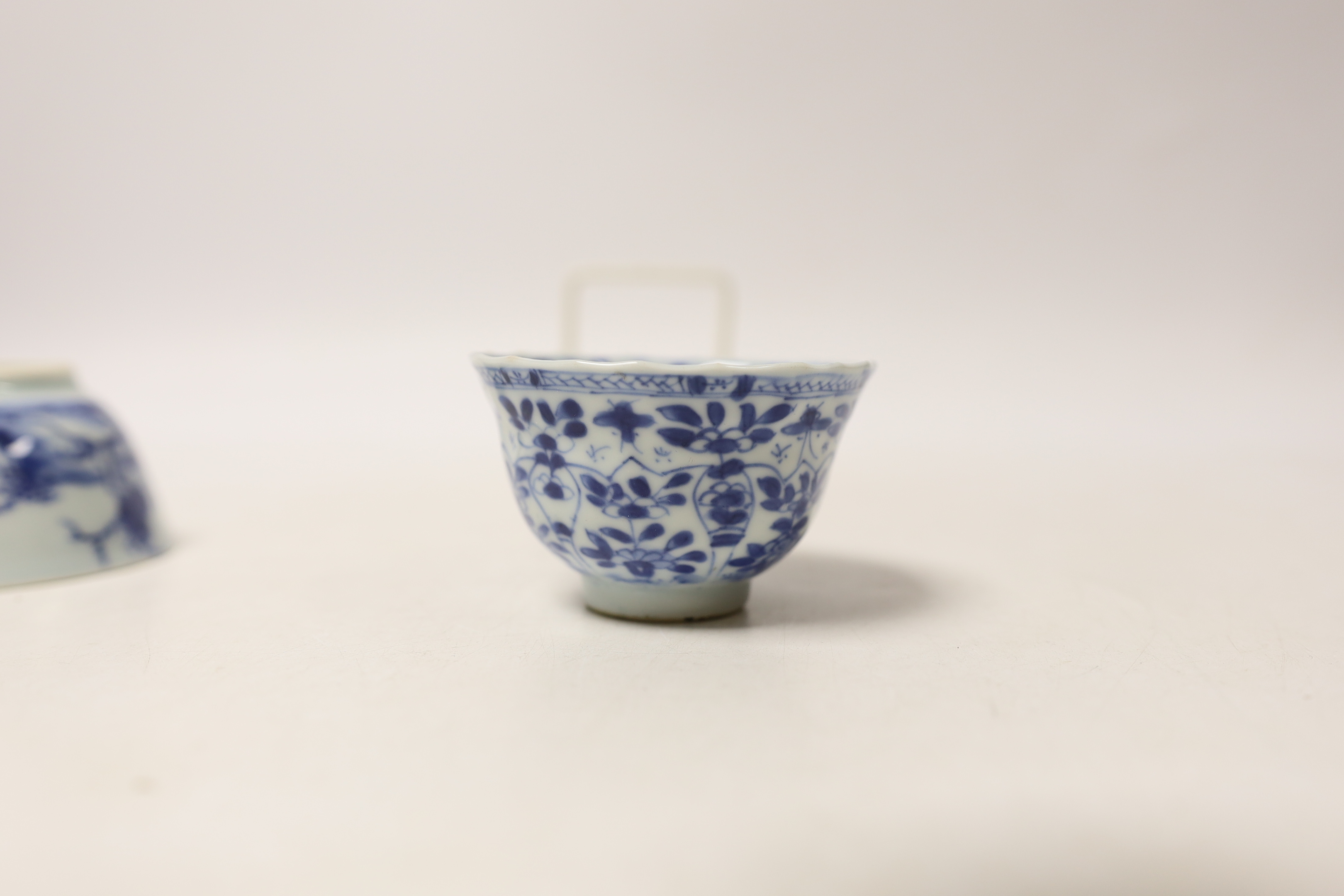 A Chinese Nanking Cargo blue and white saucer and tea bowl, and a Kangxi blue and white tea bowl, largest 11.5cm in diameter